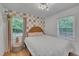 Cozy bedroom with checkered accent wall, natural light, and stylish decor for a tranquil retreat at 1717 Martin Luther King Jr Blvd, Raleigh, NC 27610