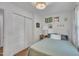 Cozy bedroom features a bed with a patterned comforter and white walls decorated with botanical prints at 1717 Martin Luther King Jr Blvd, Raleigh, NC 27610