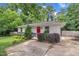 Charming single-story home with vibrant landscaping, a driveway, and a bright red front door at 1717 Martin Luther King Jr Blvd, Raleigh, NC 27610