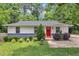 Charming single-story home with a freshly landscaped front yard and a bright red front door at 1717 Martin Luther King Jr Blvd, Raleigh, NC 27610