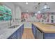 Renovated kitchen with marble countertops, blue cabinets, and stylish decorative touches at 1717 Martin Luther King Jr Blvd, Raleigh, NC 27610