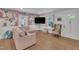 Inviting living room with floral wallpaper, comfortable seating, and wood-look flooring at 1717 Martin Luther King Jr Blvd, Raleigh, NC 27610