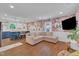 Stylish living room featuring a plush pink sectional sofa, hardwood floors, and an accent wall at 1717 Martin Luther King Jr Blvd, Raleigh, NC 27610