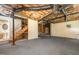 Unfinished basement space with exposed pipes, stairs, and ample room for customization at 1720 Kingston Heath Way, Raleigh, NC 27604