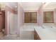 Bright bathroom featuring a shower, tub, large window, and sink with ample counter space at 1720 Kingston Heath Way, Raleigh, NC 27604