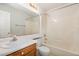 Classic bathroom featuring a tiled shower-tub combo, toilet, sink, and decorative wallpaper at 1720 Kingston Heath Way, Raleigh, NC 27604