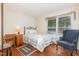 Cozy bedroom featuring a comfortable bed, chair, desk, and window with natural light at 1720 Kingston Heath Way, Raleigh, NC 27604