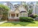 Charming home showcasing a quaint front porch and well-maintained yard at 1720 Kingston Heath Way, Raleigh, NC 27604