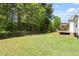 A backyard view featuring a wooden deck in a well-maintained yard at 1752 Cobblestone Dr, Creedmoor, NC 27522