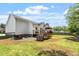 A backyard featuring a wooden deck, outdoor seating, and a grill at 1752 Cobblestone Dr, Creedmoor, NC 27522
