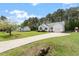 Attractive house with a sprawling green lawn and long driveway leading up to the garage at 1752 Cobblestone Dr, Creedmoor, NC 27522