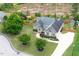 Aerial view of home with well-manicured lawn, charming landscaping, and green surroundings at 182 Brendamoore Ct, Fuquay Varina, NC 27526