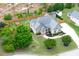 Aerial view of a landscaped home with lush greenery, fenced yard, and storage shed at 182 Brendamoore Ct, Fuquay Varina, NC 27526