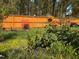Landscaped backyard with wooden fence features a tall sunflower and a variety of blooming flowers at 182 Brendamoore Ct, Fuquay Varina, NC 27526