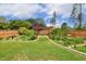 Professionally landscaped backyard with a wooden pergola and manicured lawn at 182 Brendamoore Ct, Fuquay Varina, NC 27526
