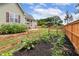 Wonderful backyard garden featuring vegetable crops and a wooden fence at 182 Brendamoore Ct, Fuquay Varina, NC 27526
