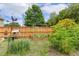 Backyard with garden, birdhouse and lush greenery, surrounded by a wood fence at 182 Brendamoore Ct, Fuquay Varina, NC 27526