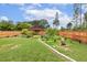 Fenced backyard with a pergola, garden, stone pathways, and mature landscaping at 182 Brendamoore Ct, Fuquay Varina, NC 27526