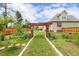 Spacious backyard with mature trees, wooden pergola, garden and lush landscaping at 182 Brendamoore Ct, Fuquay Varina, NC 27526