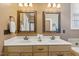 Bathroom with double vanity, framed mirrors and attractive hardware at 182 Brendamoore Ct, Fuquay Varina, NC 27526