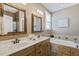 Bathroom featuring a soaking tub with tile surround and double vanity at 182 Brendamoore Ct, Fuquay Varina, NC 27526