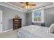 A comfortable bedroom featuring a tray ceiling, neutral carpet, and a wooden bookshelf at 182 Brendamoore Ct, Fuquay Varina, NC 27526