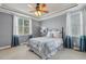 A serene bedroom featuring soft gray walls, a tray ceiling, and bright natural light at 182 Brendamoore Ct, Fuquay Varina, NC 27526
