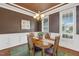 Formal dining room with an elegant chandelier, large windows, and wainscoting at 182 Brendamoore Ct, Fuquay Varina, NC 27526