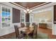 Formal dining room with an elegant chandelier, large windows, and wainscoting at 182 Brendamoore Ct, Fuquay Varina, NC 27526
