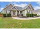 Charming home featuring manicured landscaping with flowering shrubs and elegant walkway to front entrance at 182 Brendamoore Ct, Fuquay Varina, NC 27526