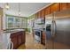Well-lit kitchen with stainless steel appliances and tiled floors at 182 Brendamoore Ct, Fuquay Varina, NC 27526