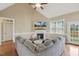 Bright living room includes a fireplace, vaulted ceiling, and an expansive couch at 182 Brendamoore Ct, Fuquay Varina, NC 27526