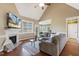 Cozy living room boasts natural light, a fireplace, and hardwood flooring at 182 Brendamoore Ct, Fuquay Varina, NC 27526