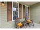 Relaxing outdoor seating on the side porch with comfortable chairs and decorative pillows at 182 Brendamoore Ct, Fuquay Varina, NC 27526