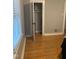 Bedroom featuring hardwood floors, neutral gray walls, and a closet with an open door at 200 S Pettigrew St, Raleigh, NC 27610