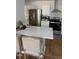 Kitchen with stainless steel appliances, white countertops, island seating and hardwood floors at 200 S Pettigrew St, Raleigh, NC 27610