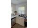 Charming kitchen area with white cabinets, modern sink fixtures, and bright natural lighting at 200 S Pettigrew St, Raleigh, NC 27610