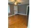 Spacious living room featuring hardwood floors, neutral paint, and a ceiling fan at 200 S Pettigrew St, Raleigh, NC 27610