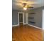 The expansive living room features hardwood flooring, floating shelves and neutral paint at 200 S Pettigrew St, Raleigh, NC 27610