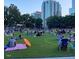 Exterior view of a crowded park scene with people relaxing on the grass at 200 S Pettigrew St, Raleigh, NC 27610