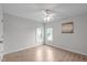 Bright bedroom with two windows, light gray walls, and a ceiling fan at 2003 Red Sage Ct, Apex, NC 27502