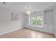 Bedroom showcasing a window seat, built-in bookcases, and wood-look floors at 2003 Red Sage Ct, Apex, NC 27502