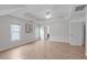 Spacious bedroom with neutral paint, light flooring, recessed lighting, three windows, and access to the bathroom at 2003 Red Sage Ct, Apex, NC 27502