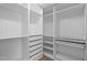 Spacious walk-in closet with custom shelving, drawers, and ample storage space for organization at 2003 Red Sage Ct, Apex, NC 27502
