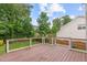Spacious wooden deck with black metal railing offers a backyard view surrounded by lush trees at 2003 Red Sage Ct, Apex, NC 27502