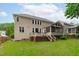 Exterior view of the home showcasing the deck, screened-in porch and the well-maintained lawn at 2003 Red Sage Ct, Apex, NC 27502