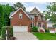 Beautiful two-story brick home with attached two-car garage and manicured front lawn at 2003 Red Sage Ct, Apex, NC 27502