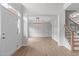 Spacious foyer with light hardwood floors, a view of dining room, and open staircase at 2003 Red Sage Ct, Apex, NC 27502