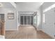 Bright foyer featuring hardwood floors, white trim, with an office showcasing built-in bookshelves at 2003 Red Sage Ct, Apex, NC 27502