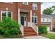 Charming brick home featuring a covered front porch and well-manicured landscaping at 2003 Red Sage Ct, Apex, NC 27502